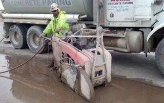 man using concrete saw