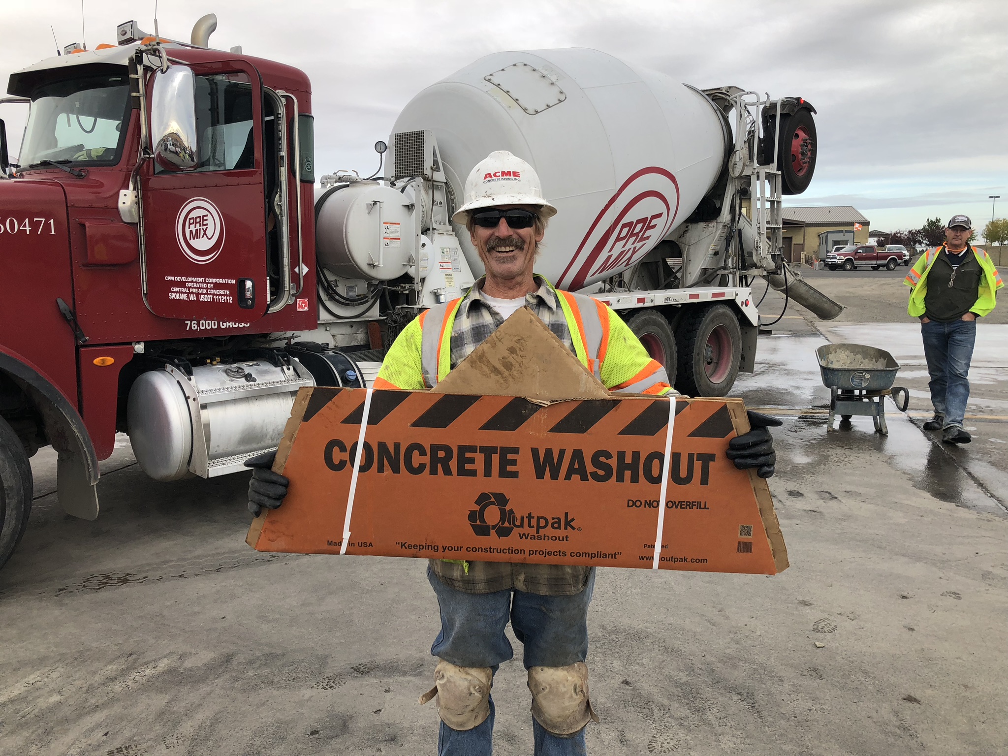 man holding concrete washout sign